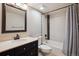 Bathroom featuring tiled shower/bathtub combination and dark vanity at 8174 Dudley Cir, Arvada, CO 80005