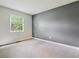 Neutral bedroom with light carpet, neutral walls and large window at 8174 Dudley Cir, Arvada, CO 80005