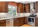 Well-equipped kitchen with modern stainless steel appliances, granite countertops, and stylish cabinets at 8174 Dudley Cir, Arvada, CO 80005