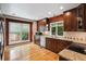 Modern kitchen with granite countertops, stainless steel appliances, and beautiful hardwood flooring at 8174 Dudley Cir, Arvada, CO 80005