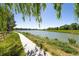Scenic view of a tranquil lake with a walking path, providing a serene escape in nature at 8174 Dudley Cir, Arvada, CO 80005