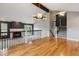 Open living room showing hardwood floors, fireplace, large window and staircase at 8174 Dudley Cir, Arvada, CO 80005