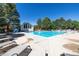 Community pool area with ample lounge chairs and a nearby cabana, offering a refreshing retreat at 8174 Dudley Cir, Arvada, CO 80005