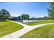 Well-maintained tennis court surrounded by lush greenery and a secure fence, ideal for recreational play at 8174 Dudley Cir, Arvada, CO 80005