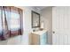 Bathroom featuring a vanity with storage and decorative mirror; neutral wall color at 9021 Rampart St, Federal Heights, CO 80260