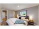 Well-lit bedroom showcasing a comfy bed, neutral walls, and a side table with a lamp at 9021 Rampart St, Federal Heights, CO 80260