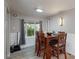 Cozy dining area featuring a wood table, comfortable seating, and modern lighting at 9021 Rampart St, Federal Heights, CO 80260