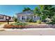 Well-kept single-story home with a stone-lined flower bed and well-manicured lawn at 9021 Rampart St, Federal Heights, CO 80260