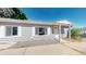 Charming home featuring gray siding, white trim, and a cozy covered front entry at 9021 Rampart St, Federal Heights, CO 80260