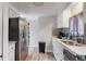 Kitchen featuring stainless steel refrigerator, ample counter space, and grey backsplash at 9021 Rampart St, Federal Heights, CO 80260