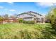Spacious backyard with lush lawn, privacy fence, a patio with a pergola, and gray-paneled home at 134 S Pontiac St, Denver, CO 80230