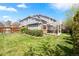 Spacious backyard with lush lawn, privacy fence, a patio with a pergola, and gray-paneled home at 134 S Pontiac St, Denver, CO 80230