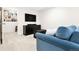 Finished basement space with TV, storage, and a comfortable blue sofa at 134 S Pontiac St, Denver, CO 80230