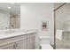 Bathroom featuring stone shower, shower glass door and large vanity at 134 S Pontiac St, Denver, CO 80230