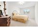 Clean bedroom featuring neutral walls, carpet, and a wrought iron headboard at 134 S Pontiac St, Denver, CO 80230