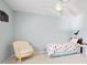 Light and airy bedroom with a ceiling fan, soft blue walls, and decor at 134 S Pontiac St, Denver, CO 80230