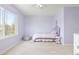 Comfortable bedroom with a large window, lilac walls and unique decor at 134 S Pontiac St, Denver, CO 80230