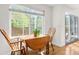 Sunlit breakfast nook area features hardwood floors and a view of the lush landscaping at 134 S Pontiac St, Denver, CO 80230
