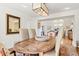 Bright dining area features a wooden table and neutral walls with decor mirror at 134 S Pontiac St, Denver, CO 80230