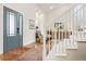 Bright entryway features hardwood floors, a stylish front door, staircase, and decor for a welcoming atmosphere at 134 S Pontiac St, Denver, CO 80230