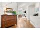 Inviting entryway features a hardwood floor and a decorative dresser with bright living room view at 134 S Pontiac St, Denver, CO 80230