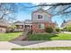 Two-story home featuring a manicured lawn, brick accents, mature trees, and a walkway to the front door at 134 S Pontiac St, Denver, CO 80230