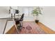 Bright home office features hardwood floors, a large desk, and a large window at 134 S Pontiac St, Denver, CO 80230