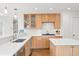 Modern kitchen boasts stainless steel appliances, wood cabinets, and an island with counter seating at 134 S Pontiac St, Denver, CO 80230