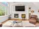 Bright living room with fireplace and large windows and comfortable leather seating at 134 S Pontiac St, Denver, CO 80230