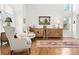 Bright living room featuring hardwood floors, white walls, elegant decor, and ample natural light at 134 S Pontiac St, Denver, CO 80230