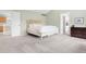 Spacious main bedroom with neutral carpet, vaulted ceiling and ensuite bathroom access at 134 S Pontiac St, Denver, CO 80230
