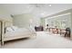 Airy main bedroom with vaulted ceiling, neutral carpet, large window, and ample natural light at 134 S Pontiac St, Denver, CO 80230