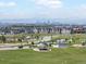 Aerial view of the neighborhood with a park, playground, and Denver skyline in the distance at 10252 E 58Th Ave, Denver, CO 80238