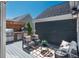 Outdoor kitchen and patio space with grill, pizza oven, and comfortable seating at 10252 E 58Th Ave, Denver, CO 80238