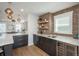 A modern bar area featuring a brick wall, a sink, and a wine cooler at 10252 E 58Th Ave, Denver, CO 80238