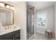 Bathroom featuring a glass enclosed shower, vanity, and lots of light at 10252 E 58Th Ave, Denver, CO 80238