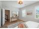 Sunlit bedroom features wood floors, stylish decor, and serene atmosphere at 10252 E 58Th Ave, Denver, CO 80238