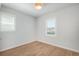 A well-lit bedroom featuring neutral walls, hardwood floors, and modern lighting at 10252 E 58Th Ave, Denver, CO 80238