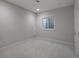 Simple bedroom with neutral walls, carpeted floors, and a small window at 10252 E 58Th Ave, Denver, CO 80238