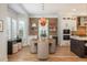 Cozy dining area features a modern light fixture and a brick accent wall at 10252 E 58Th Ave, Denver, CO 80238