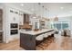 Modern kitchen features a large center island, stainless steel appliances, and sleek finishes at 10252 E 58Th Ave, Denver, CO 80238