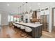 Spacious kitchen with an expansive island, stainless appliances, and hardwood floors at 10252 E 58Th Ave, Denver, CO 80238