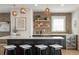 Modern kitchen with a black island, white countertops, and decorative lighting fixtures at 10252 E 58Th Ave, Denver, CO 80238