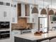 Well-equipped kitchen highlighting stainless appliances, custom cabinets, and sleek countertops at 10252 E 58Th Ave, Denver, CO 80238
