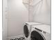 Clean and modern laundry room with front loading machines and ample storage at 10252 E 58Th Ave, Denver, CO 80238