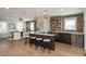 Spacious living area with a bar, brick accent wall, and ample seating at 10252 E 58Th Ave, Denver, CO 80238