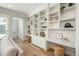 Spacious living room with custom built-ins, stylish decor, and lots of natural light at 10252 E 58Th Ave, Denver, CO 80238