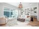 Open concept living space filled with natural light boasts custom built-ins and sleek decor at 10252 E 58Th Ave, Denver, CO 80238