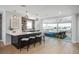 Spacious living area with bar, and access to an outdoor patio at 10252 E 58Th Ave, Denver, CO 80238
