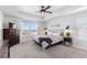 Main bedroom with large windows, a ceiling fan, and dresser at 944 Black Saddle St, Elizabeth, CO 80107